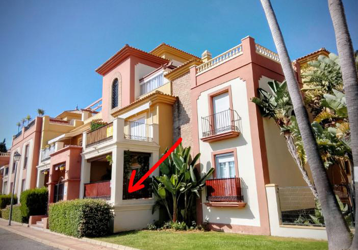 Edificio y terraza señalada con flecha roja